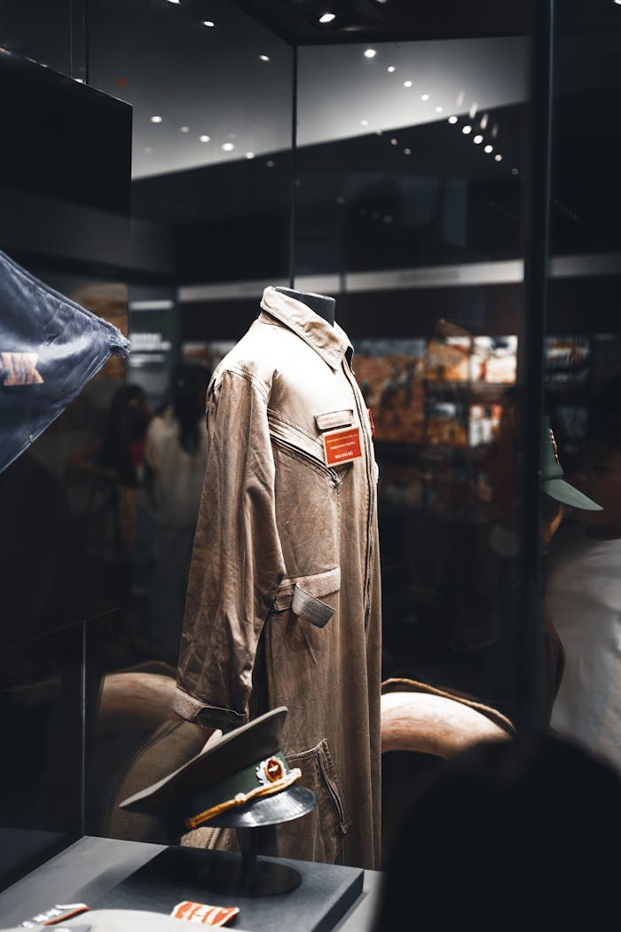 Showcase of a vintage military uniform in a well-lit museum exhibit, capturing historical essence.